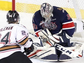 Luke Coleman of the Calgary Hitmen tries to score on Regina Pats goalie Tyler Brown in WHL action at the Scotiabank Saddledome in Calgary on Feb. 8, 2017.