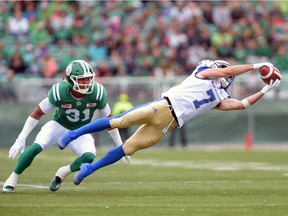 The Winnipeg Blue Bombers' Weston Dressler, right, makes the most spectacular of his seven catches during the 2016 Labour Day Classic against his former team, the Saskatchewan Roughriders.