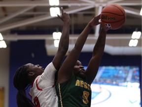 The McGill Martlets' Marie-Love Michel, left, battles for the ball with the University of Regina Cougars' Kyanna Giles on Thursday at the U Sports women's basketball championship in Victoria.