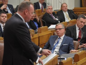 Premier Brad Wall listens to Saskatchewan Finance Minister Kevin Doherty's 2017 budget speech at the Legislative Building in Regina on Wednesday, March 22, 2017.