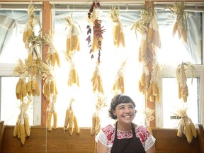 Mariana Brito sits surrounded by drying corn and peppers at her home.