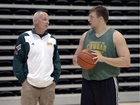 Jeremy Zver, right, shown in a file photo with Cougars men's basketball head coach Steve Burrows, is hoping to be drafted in the CFL after switching to football in 2013.