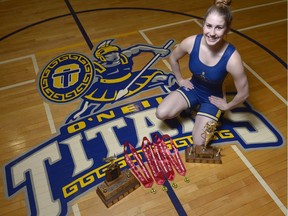 O'Neill wrestler Sara Tokarz is shown with her trophies and gold medals.