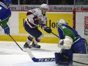 Regina Pats centre Sam Steel centre hunts for an opportunity around Swift Current Broncos goalie Taz Burman during WHL action on Wednesday at the Brandt Centre.