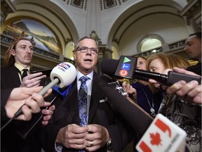 Premier Brad Wall speaks with journalists in the Rotunda of the Legislative Building in Regina on Monday, March 20, 2017. Wall says the province's budget will take three years to balance and major changes to taxes are coming.