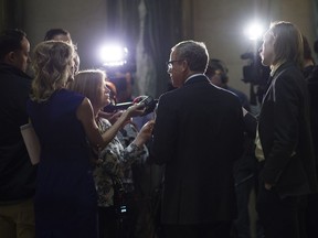 Premier Brad Wall speaks with journalists in the Rotunda of the Legislative Building in Regina on Monday. March 20, 2017.