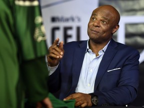 Football legend Warren Moon signs autographs during CFL Week in Regina on Thursday.