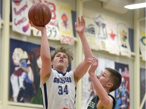 The Regina Christian Grizzlies' Zach Biegler, 34, shoots while the Birch Hills Marauders' Josh Opseth defends during Hoopla action Friday at Luther College High School's Semple Gymnasium.
