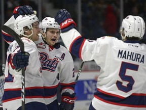 Regina Pats centre Sam Steel (middle) celebrates a first-period goal with Dawson Leedahl and Josh Mahura during Saturday's WHL playoff game against the Calgary Hitmen.