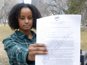 Maria Aman holds up a letter she received from the University of Regina Students' Union board.