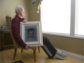 Jim Brass holds a portrait of his wife Marion at his home.