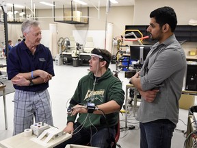 University of Regina kinesiology professor Patrick Neary, from left, University of Regina rugby player Alexander Leach and Jyotpal Singh, master of science in kinesiology candidate, demonstrate concussion testing at the U of R.