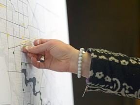 A woman places a dot on a map indicating the approximate location of a business. The activity was part of an open house for local businesses and event organizers regarding a proposed smoking bylaw that would ban most smoking in most public places and on restaurant patios. MICHAEL BELL / Regina Leader-Post.