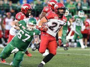 Jeff Hecht (#27) when he played with the Calgary Stampeders runs back an interception while Saskatchewan Roughriders offensive lineman Dan Clark (#67) tries to tackle him during CFL preseason action at Mosaic Stadium in Regina on June 19, 2015.