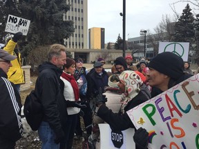 Supporters of the Canadian Coalition of Concerned Citizens on the left have a heated discussion with counter protesters on the right about M-103 during a protest at Regina City Hall on Saturday, Mar. 4. PHOTO/Ashley Robinson