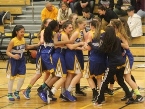 The O'Neill Titans junior girls basketball team celebrates a city title on Thursday.