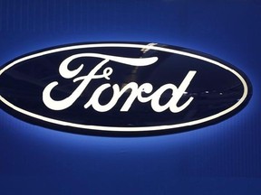 This Feb. 11, 2016, file photo shows the Ford logo on display at the Pittsburgh International Auto Show in Pittsburgh. Ford is recalling 53,000 2017 F-250 trucks because they can roll away even when they are parked due to a manufacturing error. THE CANADIAN PRESS/AP/Gene J. Puskar, File