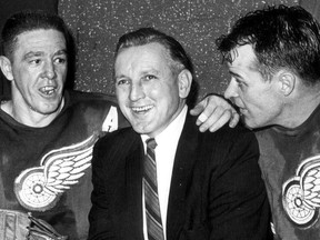 Detroit Red Wings coach Sid Abel, second from left, is joined by Red Wings Marcel Pronovost, left, Gordie Howe, second from right, and Val Fonteyne, right, after defeating Toronto in an NHL playoff game in Detroit, in this March 28, 1961 photo.