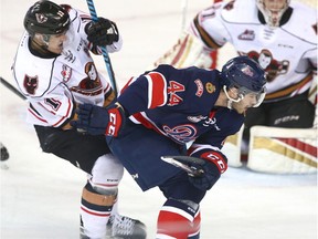 Regina Pats defenceman Connor Hobbs (44) battles Calgary Hitmen's 
Beck Malenstyn during Thursday's WHL playoff action.