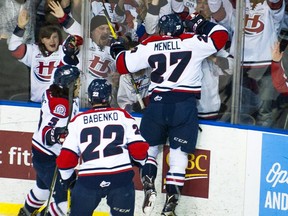 Lethbridge Hurricanes defenceman Brennan Menell celebrates the first goal of the night along with teammates Tyler Wong and Egor Babenko on Tuesday. Lethbridge went on to beat the Regina Pats 3-1 in Game 3 of the WHL's Eastern Conference final at the Enmax Centre.