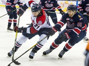 Lethbridge Hurricanes forward Ryan Vandervlis battles with Regina Pats defenceman Liam Schioler during Game 4 of the WHL's Eastern Conference final on Wednesday at the Enmax Centre in Lethbridge.