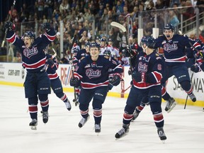 The Regina Pats pour off the bench to celebrate their Eastern Conference final win over the Lethbridge Hurricanes in Game 6 on Sunday at the Enmax Centre in Lethbridge.