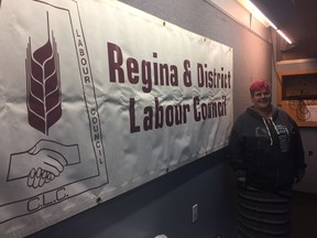 Michelle Lang, president of PSAC local 4005 who represents Casino Regina workers stands next to the Regina and District Labour Council sign at the council's annual AGM on Saturday. Lang was a member of a panel who discussed how provincial cuts are affecting workers. PHOTO ASHLEY ROBINSON