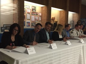 Members of the Regina Human Service Partnership sign off on a Community Violence Threat Risk Assessment and Support Protocol.