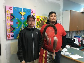 Jr. Chief Thomas Kaiswatum holds eagle staff with Piapot Chief Jeremy Fourhorns.