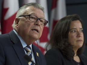 Jody Wilson-Raybould, Minister of Justice and Attorney General of Canada listens as Ralph Goodale, Minister of Public Safety and Emergency Preparedness responds to a question after announcing changes regarding the legalization of marijuana during a news conference in Ottawa, Thursday April 13, 2017.