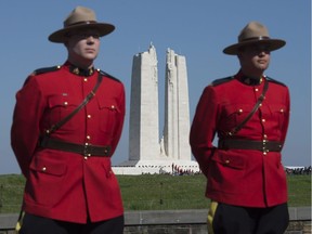 RCMP officers stand at the entrance to the Vimy Memorial before ceremonies to mark the 100th anniversary of the battle, north of Arras, France, Sunday, April 9, 2017.