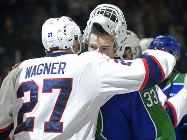 Regina Pats forward Austin Wagner hugs Swift Current Broncos goalie Jordan Papirny at the end of the seventh game of their series at the Brandt Centre.