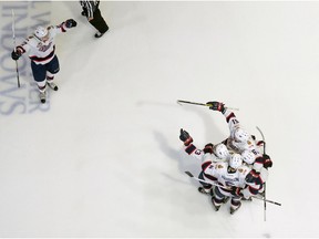 Regina Pats forward Austin Wagner, top left, celebrates the line's goal during the seventh game of the series at the Brandt Centre.