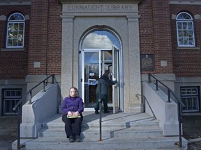 REGINA, SASK : April 2, 2017 - Joanne Havelock, chair of the Friends of the Regina Public Library, sits on the steps of Connaught Library. Friends of the Regina Public Library are among many groups and citizens around the province trying to press the provincial government to rescind the cuts announced in the provincial budget. MICHAEL BELL / Regina Leader-Post.