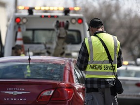 A City of Regina parking enforcement officer issues a ticket on the 1700 block of 13th Avenue in Regina.