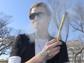 John Stewart smokes a huge joint during a 420 rally held in Victoria Park.