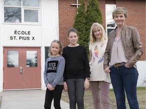 Colleen Silverthorn with her three daughters — from left Sydney, Grade 2, Allie, Grade 5 and Sam, Grade 8 — in front of École St. Pius X school in Regina.