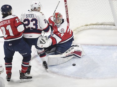 Lethbridge Hurricanes Ryan Vandervlis, left, and goalie Stuart Skinner try to keep  Regina Pats Sam Steel way from the loose puck in WHL playoff action at the Brandt Centre in Regina.