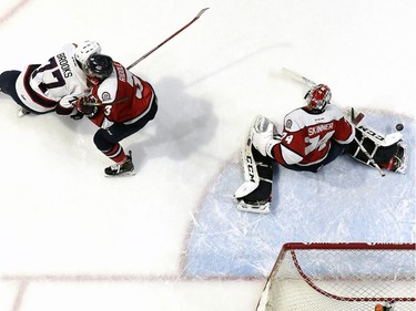 Lethbridge Hurricanes  goalie Stuart Skinner gets a pad out to make a save on Saturday at the Brandt Centre. Adam Brooks, left, had the last laugh by scoring the winning goal in overtime.