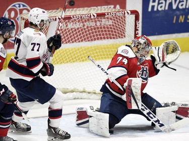 Regina Pats Adam Brooks (77) watches the puck go over Lethbridge Hurricanes goalie Stuart Skinner in WHL playoff action at the Brandt Centre in Regina.