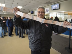 Keith Pratt holds up his  Game 5 Regina Pats playoff tickers at the Brandt Centre box office.