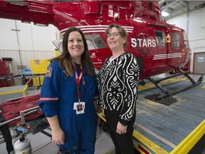 Raegan Gardner, left,   STARS flight nurse, and former STARS patient Carrie Derin pose for a portrait prior to the 5th anniversary celebration in Regina.  Derin was involved in a all terrain vehicle accident and become a STARS VIP (Very Important Patient).