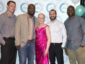Saskatchewan Roughriders greats, left to right, Chris Getzlaf, Wes Cates, Weston Dressler and Darian Durant pose with cancer survivor Fran Doering during Tuesday's charity event at the Conexus Arts Centre.