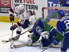 Regina Pats centre Adam Brooks tries a wraparound on Swift Current Broncos goalie Jordan Papirny during WHL playoff action at the Brandt Centre on Thursday.