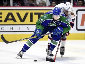 Swift Current Broncos forward Lane Pederson and Regina Pats forward Jonathan Smart fight for the puck in Game 2 of their playoff series. TROY FLEECE / Regina Leader-Post