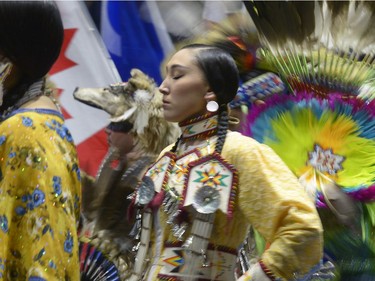 A woman participates in the grand entry at the First Nations University of Canada spring powwow at the Brandt Centre.