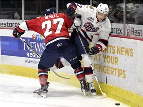 Lethbridge Hurricanes defenceman Brennan Menall, 27, ties up Regina Pats forward Austin Wagner along the boards during a WHL game at the Brandt Centre on Feb. 28. The Pats and 'Canes will meet in the Eastern Conference final, beginning Friday in Regina.