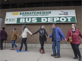 Protesters make a human chain outside the Saskatchewan Transportation Company (STC) depot in Saskatoon on Friday, March 31, in reaction to the provincial budget.