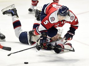 The Lethbridge Hurricanes' Tyler Wong, 5, and Dawson Leedahl of the Regina Pats had a memorable dispute during their teams' WHL playoff series. Wong and Leedahl are shown in Game 2 of the series.