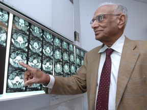 Neurosurgeon Dr. Krishna Kumar looks over X-Rays in his Regina office in November 2008.